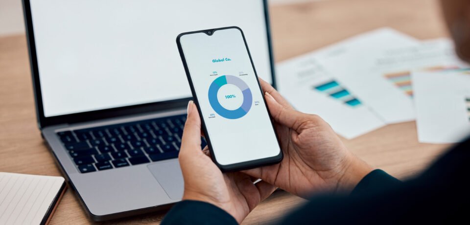 Closeup, business and employee with smartphone, mockup and data analysis for sales growth, global a.