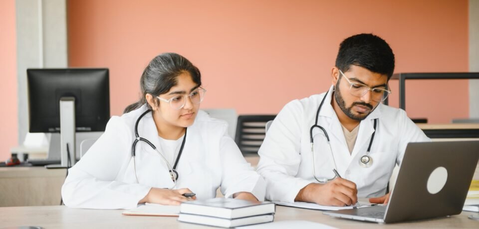 University, education, medicine, anatomy concept. Multiracial indian medical students in classroom, studying.