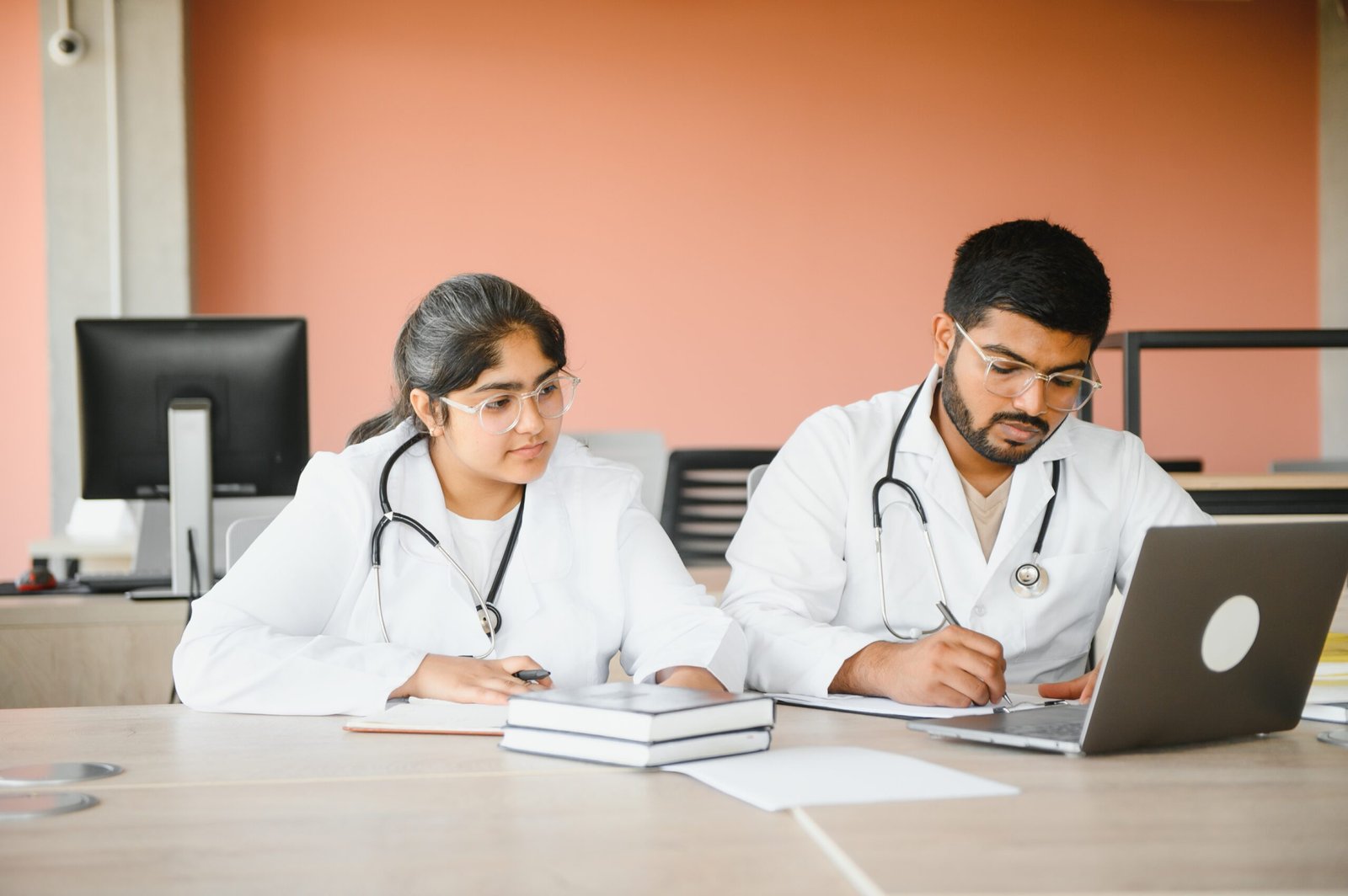 University, education, medicine, anatomy concept. Multiracial indian medical students in classroom, studying.