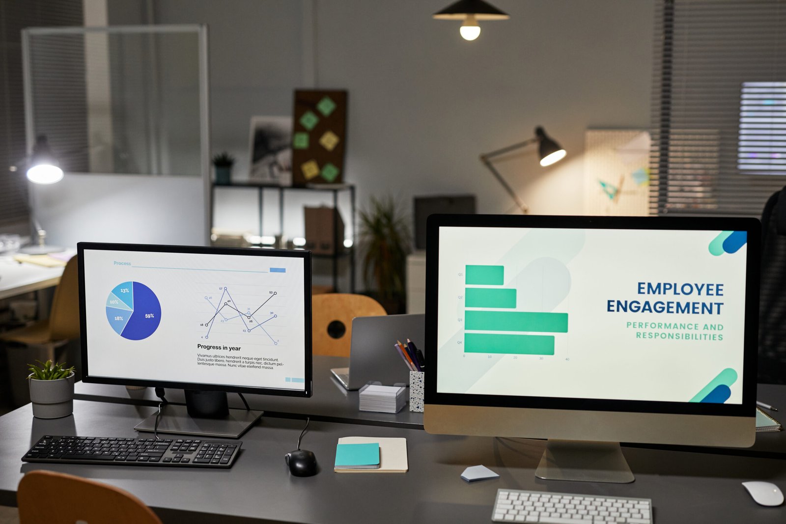Background image of two computer monitors in office with Employee engagement charts, copy space