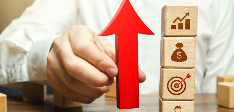 Businessman holds an up arrow near business attributes. Expansion of business company. Using new approaches and tools. Development of leadership organizational skills. Entrepreneurship management.