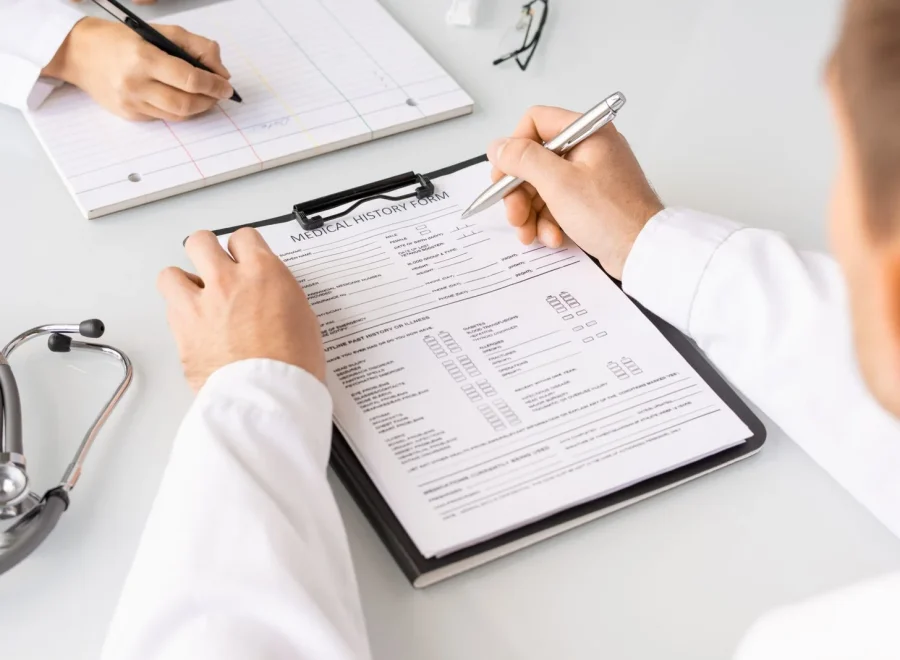 hands-of-doctor-filling-in-medical-history-forms-o-2025-03-15-07-27-08-utc-scaled