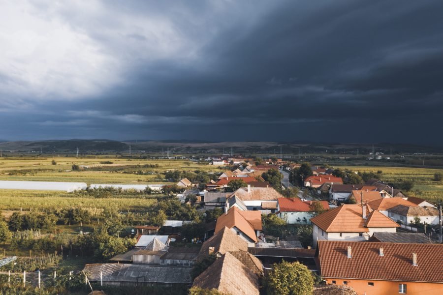 Aerial view of a small village with stormy sky in Transylvania, Romania.
